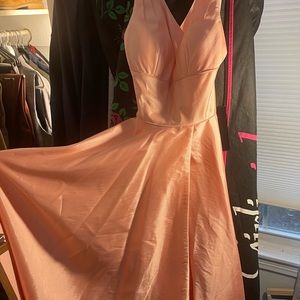 Rich metallic A-line with skirt slit, deep-V neckline, and criss-cross back.